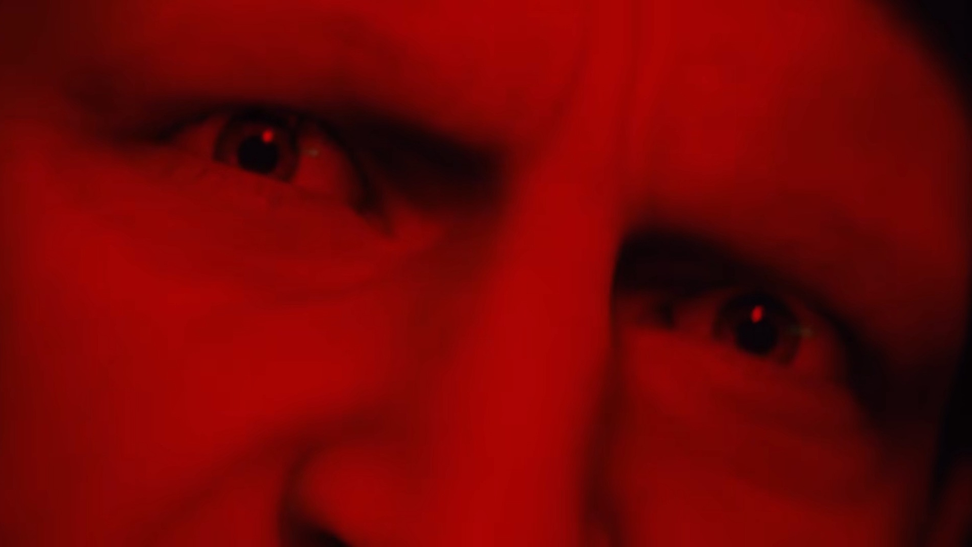 Arc Raiders trailer screenshot of a man's face in red lighting