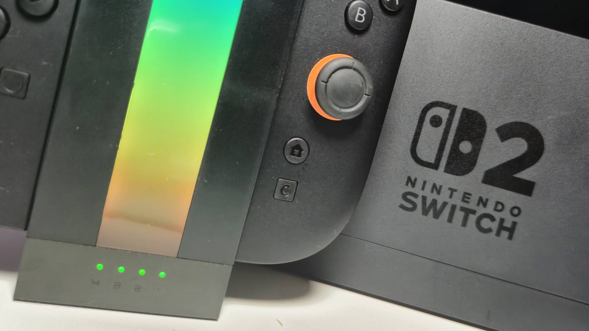 Close up of the bottom of the Jsaux Energy flow with a Switch 2 sitting behind it.