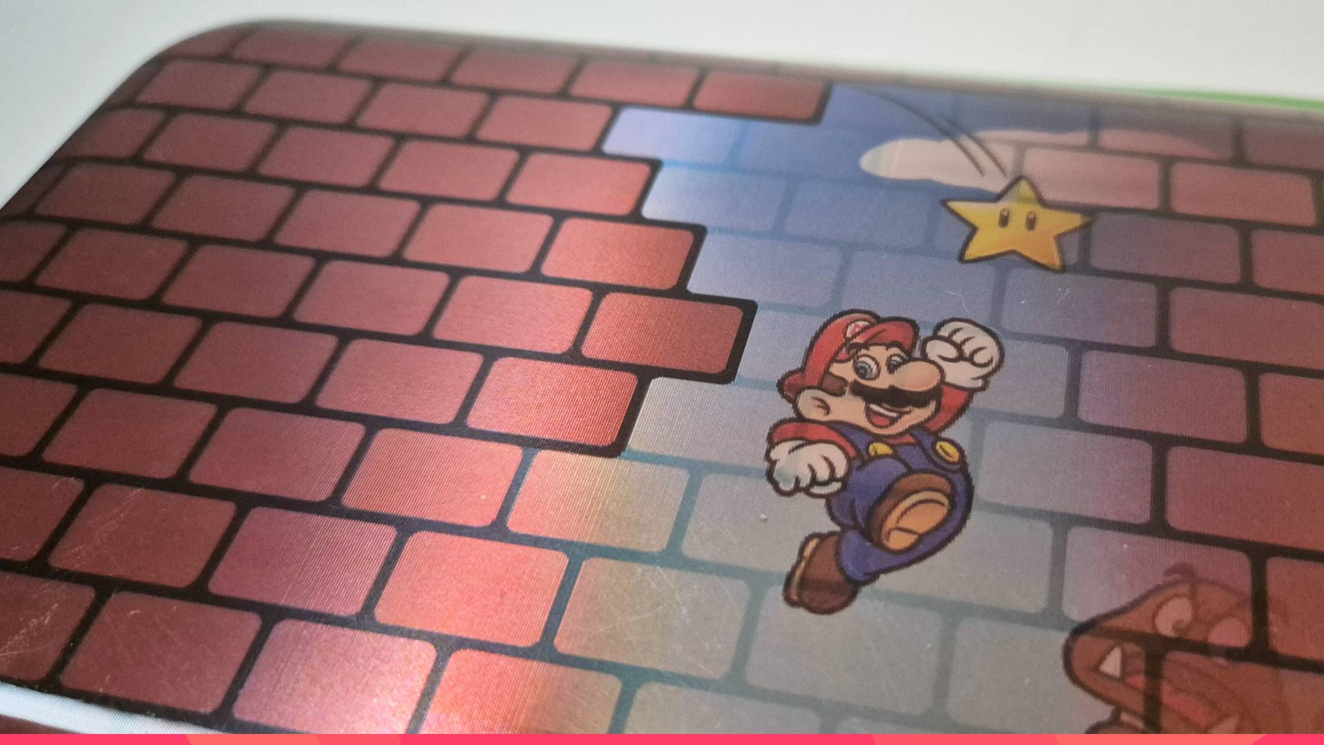 Photo of the front of a Switch 2 case showing a lenticular Super Mario design revealing through a brick pattern.